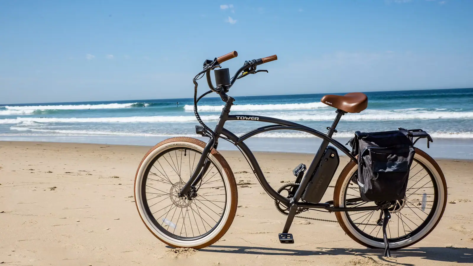 A single-speed cruiser bicycle standing on the sand at the beach in daylight