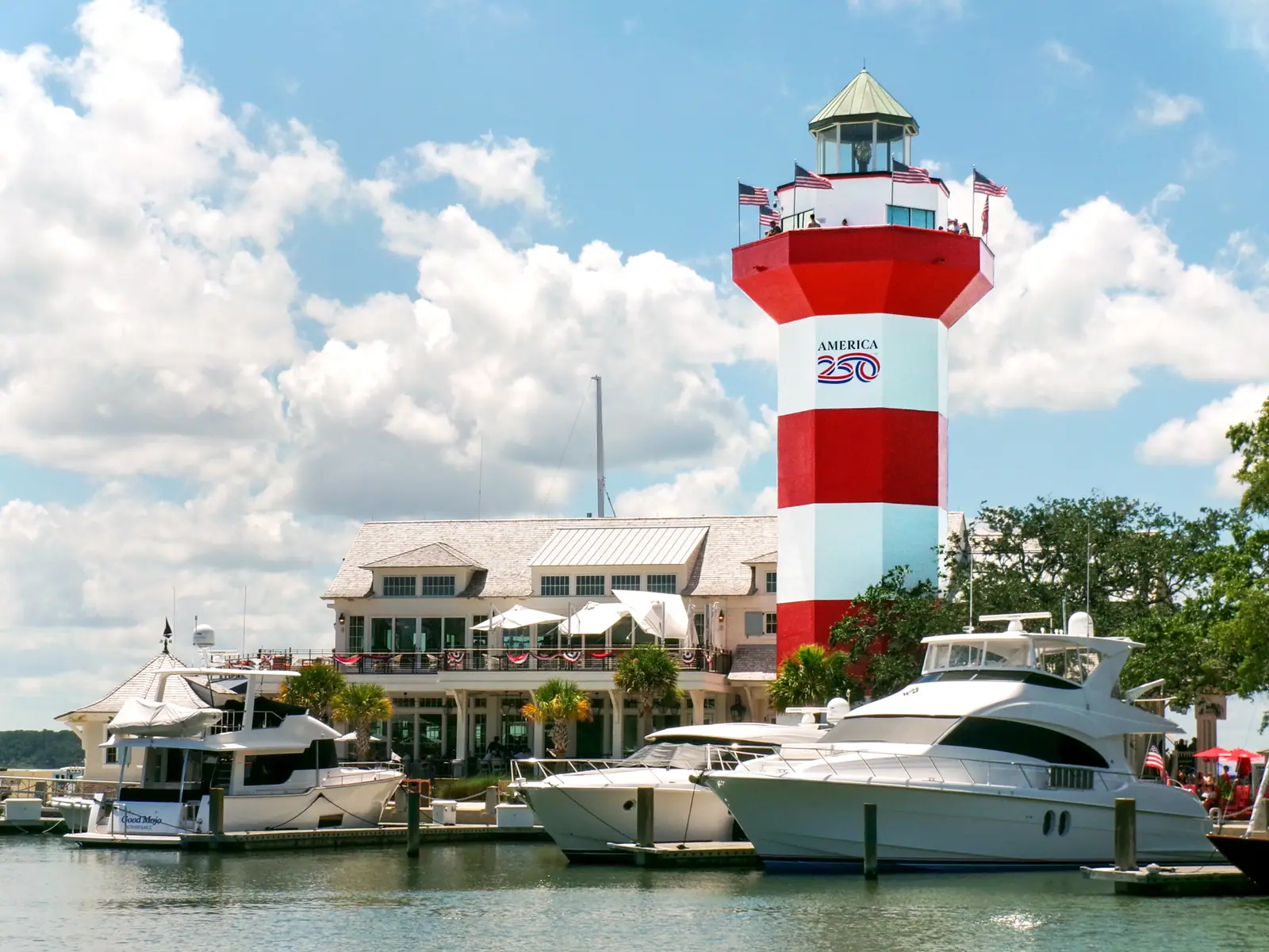 The red-and-white Harbour Town lighthouse above the marina shops and moored boats in Sea Pines